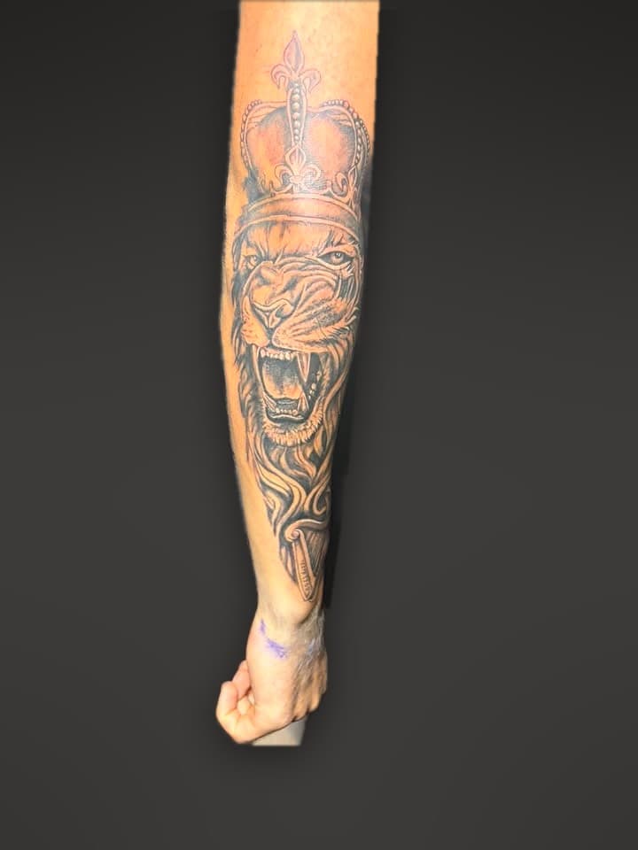 Crowned lion forearm tattoo by Dimitar Penchev